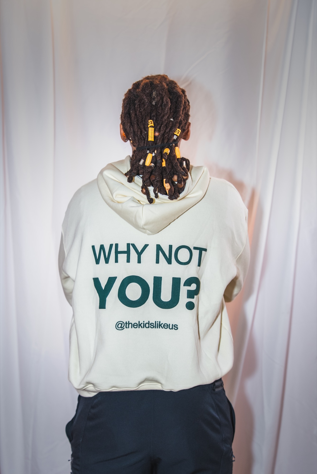 The Why Not You? back print on the cream hoodie